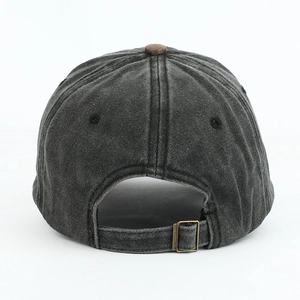 Detail of adjustable metal buckle and contrast brown button on vintage baseball cap back