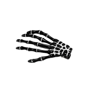 Gothic skeleton hand hair clip with black dripping oil and white bone details