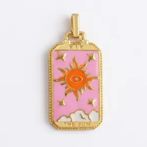 Macro detail of The Sun tarot pendant with gold plating and colorful enamel inlay