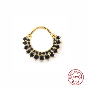 Macro detail of gold S925 sterling silver hoop earring with black zirconia inlays
