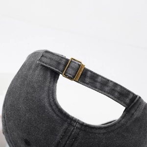 Adjustable back strap of charcoal gray washed cotton baseball cap with bronze metal buckle