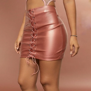 Detail of pink PU leather mini skirt featuring lace-up design and metal eyelets