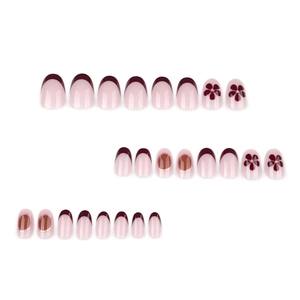 Short round press-on nails with wine red French tips and delicate floral patterns