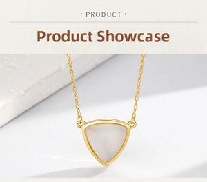 Detailed view of the gold triangle pendant set with a polished white moonstone