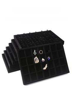 Detail of multi-grid black velvet jewelry display tray for rings and earrings