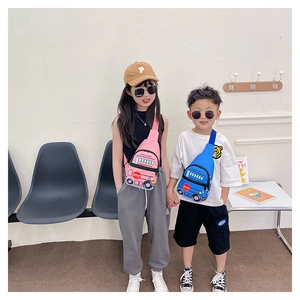 Kids school bus crossbody chest bag in blue and pink worn by young models