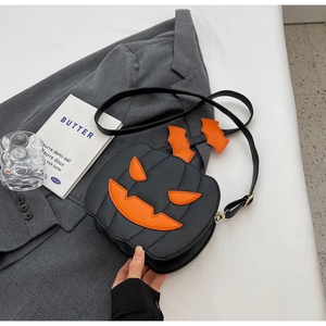 Detail of creative pumpkin-shaped crossbody bag on a grey blazer in a stylish setting