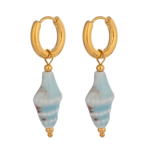 Detailed close-up of ceramic conch earrings with gold metal hoops and blue shell pendants