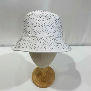 Close-up of sparkling rhinestones on a white cotton bucket hat for sun protection
