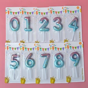 Flat lay of galaxy gradient 0-9 birthday candles with gold glitter on pink background