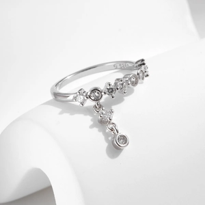 Polished S925 sterling silver ring featuring sparkling zircon row and a dangling tassel charm