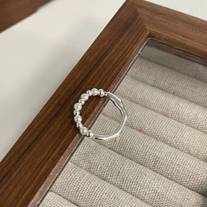 Minimalist S925 sterling silver ring featuring elegant white pearls on a wooden jewelry box