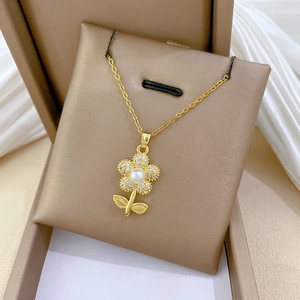 Macro detail of a golden flower pendant with shimmering crystals and a center pearl