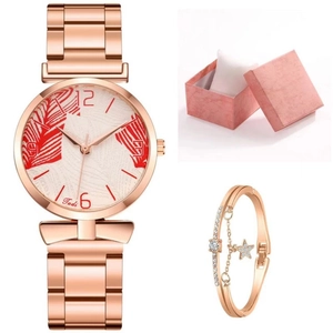 Detail of rose gold watch with red feather dial, sparkling star bracelet, and gift box
