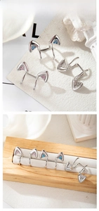 Detailed view of cat ear ear cuffs with micro-set pink, blue and white zircons