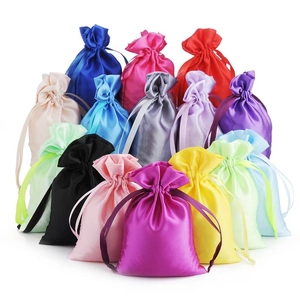 Pile of colorful satin drawstring bags in multiple vibrant silk-like fabric finishes