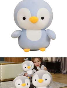 Detailed size comparison of soft penguin plush toys in blue and gray colors