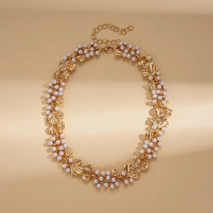 Close-up of vintage pearl flower leaf necklace with gold metal clasp and adjustable chain