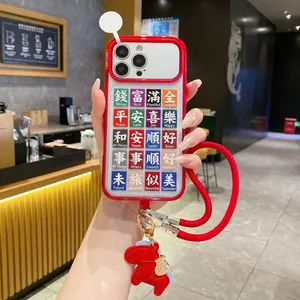 Detail of red iPhone case with festive Chinese slogans, woven lanyard and pony charm
