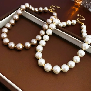 Baroque pearl necklace set with large white and champagne beads on a jewelry box