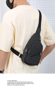 Close-up of black canvas chest bag with adjustable strap and Sport leather patch