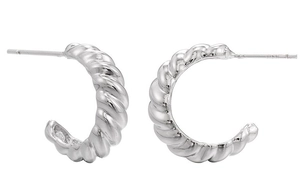 Macro detail of silver croissant twist earrings showing the S925 hallmark stamp