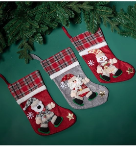 Three festive Christmas stockings featuring a bear, Santa, and snowman on a green background