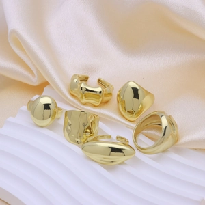 Minimalist 18k gold plated copper rings in various geometric styles on elegant display