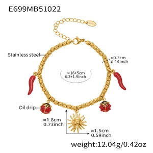 Detail view of stainless steel charm bracelet with red chili and ladybug oil drip pendants