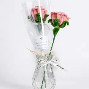 Pink handmade pipe cleaner rose bouquet in a glass vase with a gift tag and ribbon