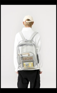 Rear view of a transparent PVC backpack showing large storage capacity for books and magazines