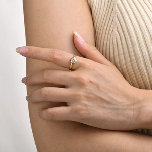 Close-up of a model wearing a gold teardrop-shaped zircon ring with adjustable band
