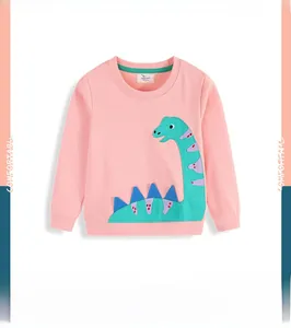 Detail of pink long-sleeved kids sweatshirt featuring a green dinosaur applique embroidery