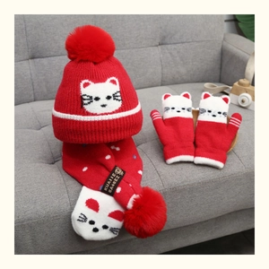 Kids winter set featuring red knit hat scarf and mittens with white cat patterns