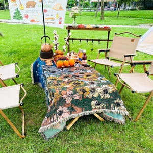 Close-up of Bohemian floral jacquard knit blanket with fringed edges in outdoor camping