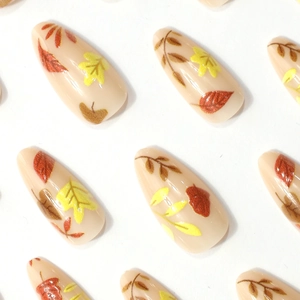 Glossy long almond press-on nails with warm autumn maple leaf patterns for women