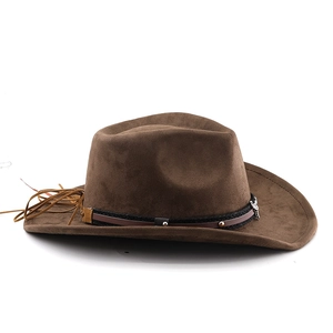 Detail of dark brown western cowboy hat with suede texture, silver skull and tassel
