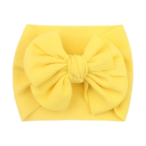 Soft elastic yellow baby headband featuring a large waffle texture double bow design