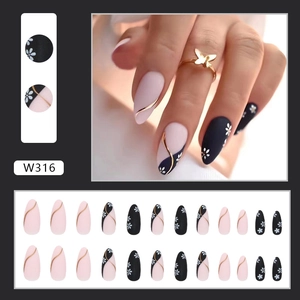 Matte almond press-on nails with pink and black patchwork and daisy floral designs