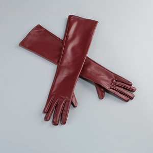 Detailed view of long dark red premium leather gloves in a crossed flat lay arrangement