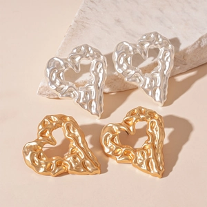 Minimalist metallic heart earrings in gold and silver with liquid metal texture finish