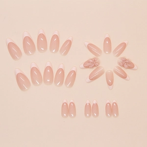 Detailed view of pink French almond press-on nails with sweet 3D bow accent decorations