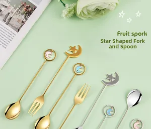 Flat lay of celestial themed gold and silver stainless steel dessert spoons and fruit forks