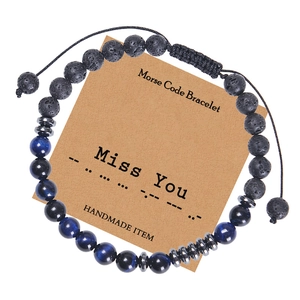 Detail of Morse code bracelet featuring blue tiger eye beads and black lava stones