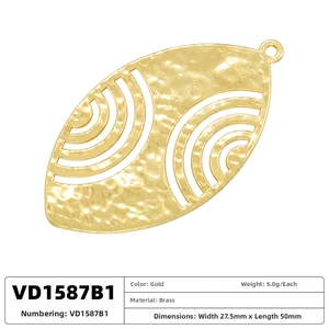 Vue macro d'un pendentif ovale en laiton doré avec texture martelée et motifs évidés