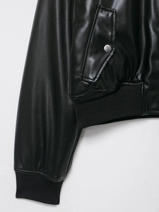 Detail of black faux leather flight jacket showing ribbed cuffs and flap pocket design
