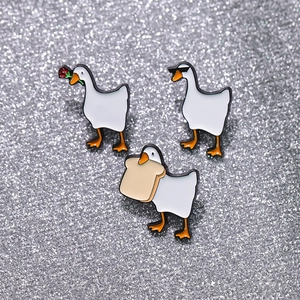 Funny white enamel goose brooch set with sunglasses and rose on silver glitter background