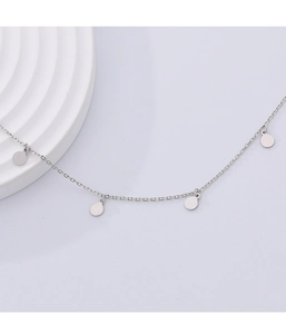 Detail shot of a minimalist 925 sterling silver chain with four polished round discs