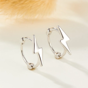 Detailed macro view of S925 sterling silver lightning bolt hoop earrings with polished finish