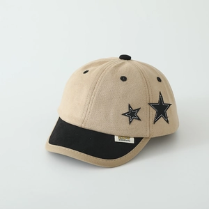 Detail of khaki kids baseball cap featuring black star embroidery and branded woven label